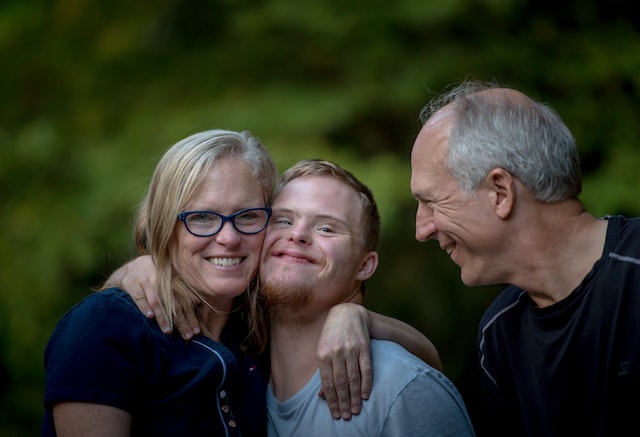 boy with special needs and his family embracing