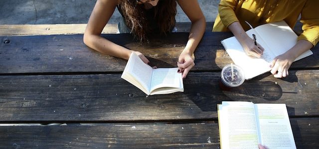 students studying together on a bench